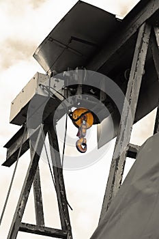 Old electric power crane hoist on a steel frame. photo