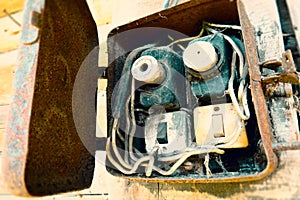 Old electric power supply boxes. Industrial background. Overloaded electrical circuit causing fuse to break. Electricity short