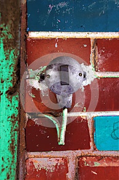 Old electric switch on a brick wall