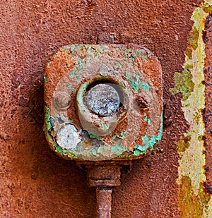 Old electric switch on a rusty iron wall