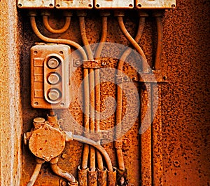 Old electric switch on a rusty iron wall