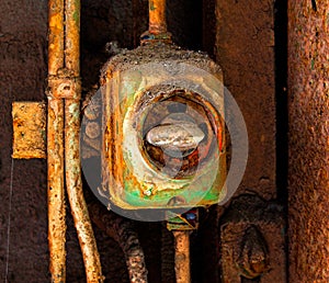 Old electric switch on a rusty iron wall