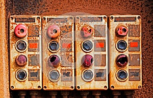 Old electric switches on rusty iron wall