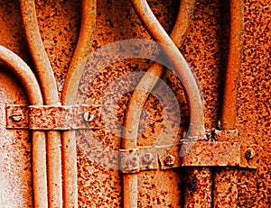 Old electrical cables on rusty iron wall