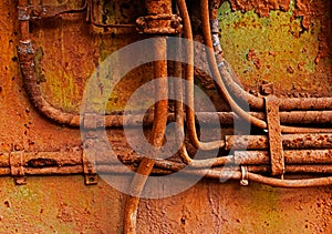 Old electrical cables on the rusty iron wall