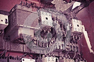 Old electrical control panel inside a damaged metal junction box