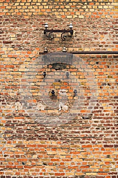 Old electrical fuses on brick wall structure