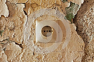 Old electrical outlet on decrepit wall