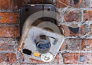 Old electrical panel on a brick wall