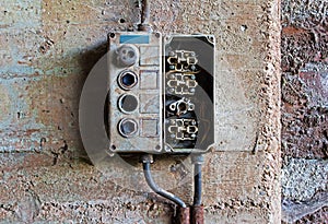 Old electrical panel on concrete wall