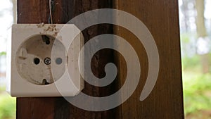 Old Electrical Socket on Wooden Wall Outdoors