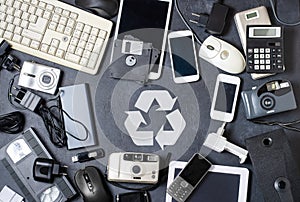 Old electronic devices on a dark background. The concept of recycling and disposal of electronic waste.