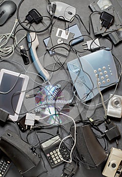 Old electronic devices on a dark background. The concept of recycling and disposal of electronic waste.