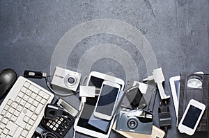 Old electronic devices on a dark background. The concept of recycling and disposal of electronic waste. Copy space