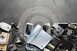 Old electronic devices on a dark background. The concept of recycling and disposal of electronic waste. Copy space