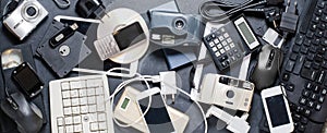 Old electronic devices on a dark background. The concept of recycling and disposal of electronic waste.