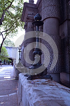 An old, elegant and gothic lamp post on the street of London