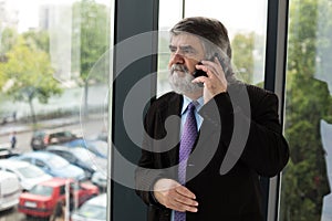 Old elegant men talking at cellphone