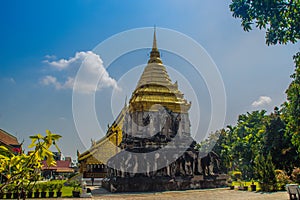 Old elephant chedi with golden top pagoda at Wat Chiang Man or Wat Chiang Mun, the oldest temple in Chiang Mai, Thailand, built in