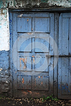 Old embossed wooden door painted in blue