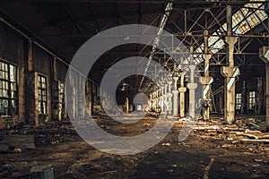 Old empty abandoned and ruined factory hall or warehouse inside interior