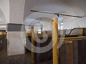 Old empty horse stable stall block in historical baroque farm Benice