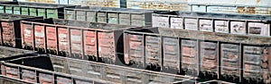 Old empty rusty train cars on rails in summer day