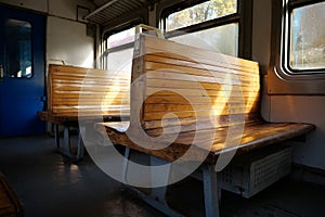 Old empty wagon of train. Wooden seats in an empty coach of train