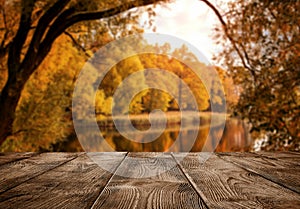 Old empty wooden table over the lake