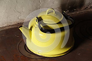 Old enameled yellow kettle