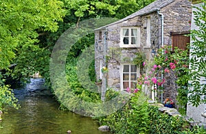 Old English cottage on river photo