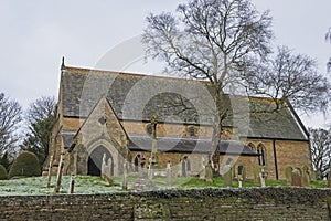 Old English rural village church with graveyard cemetary