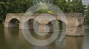 Old eroded brick construction in water