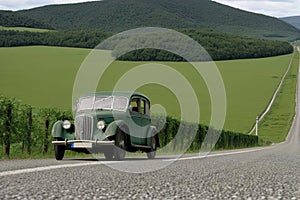 Old european car driving on a country road