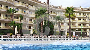 Old european hotel with pool and palms.