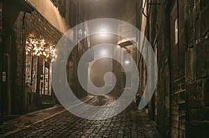 Old European narrow empty street of medieval town on a foggy evening. Taken in Bergamo, Citta Alta, Lombardia