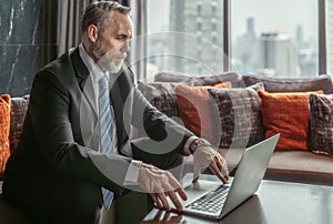 Old executive manager director working with note book on the desk