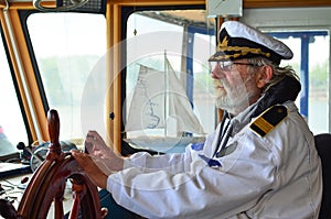 Old experienced captain in navigation cabin