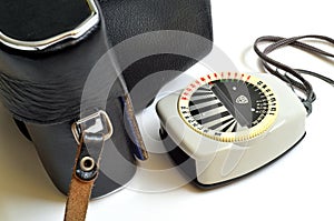 Old exposure meter and camera in leather case