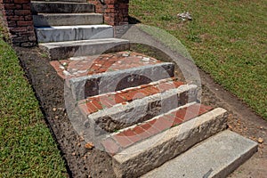 Old exterior steps and landings of rusticated stone, brick, and marble