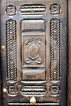 Old external wooden door inlaid with brass handle