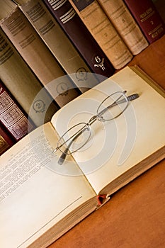 Old eyeglass on a old book photo