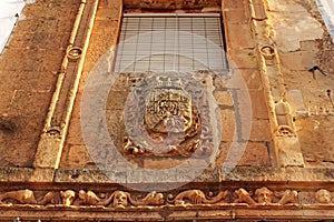 Old facade of majestic house with coat of arms in Alcaraz, Spain