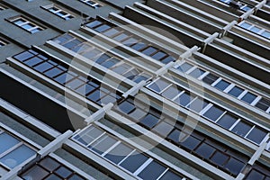 Old facade of a soviet ussr concrete constructivism brutalism centipede octopus aviator`s block house with rectangular windows.