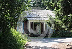 An old facade of a wooden house in a Siberian village with a carved door