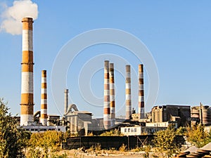 Old factory chimneys on industrial site area