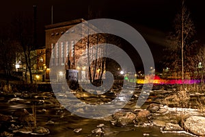 Old factory by the river at night