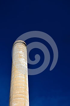 Old Factory Smokestack on a Clear Sunny Day with Blue Skies