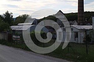 Old Factory with smokestack and tower in Majdan Male Karpaty mountains near Horne Oresany, west Slovakia