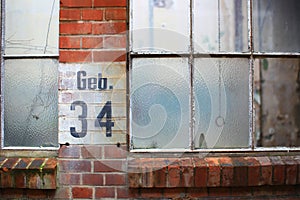 Old factory windows with the German inscription Geb. 34 (building 34)